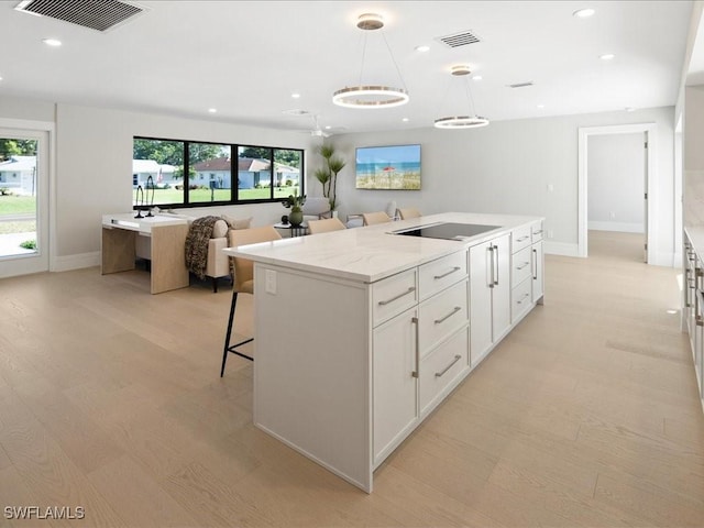 kitchen with visible vents, black electric cooktop, white cabinets, and recessed lighting