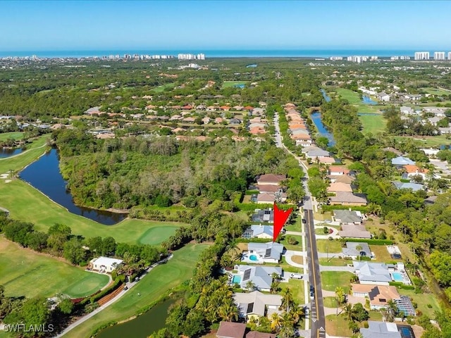 birds eye view of property with a water view, a residential view, and view of golf course
