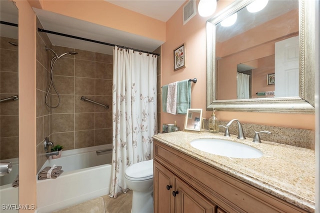 full bath with tile patterned floors, visible vents, shower / bath combo with shower curtain, toilet, and vanity