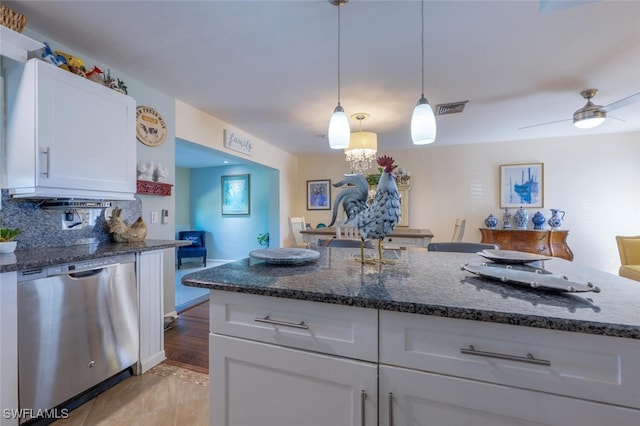 kitchen with dark stone countertops, visible vents, white cabinets, dishwasher, and backsplash