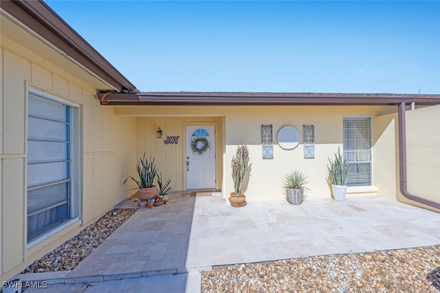 entrance to property with a patio