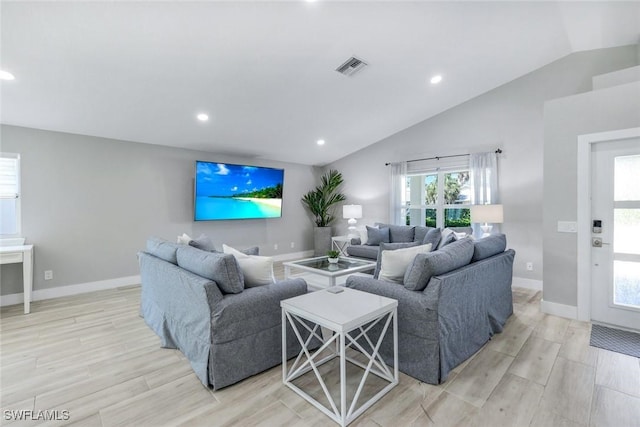 820 102nd Ave N, Naples, FL 34108 - living room with wood tiled floor, lofted ceiling, visible vents, and recessed lighting