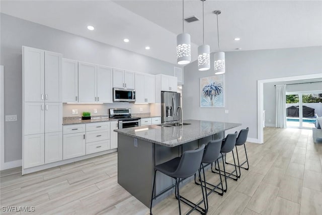 820 102nd Ave N, Naples, FL 34108 - kitchen featuring white cabinetry, a sink, stainless steel appliances, and visible vents