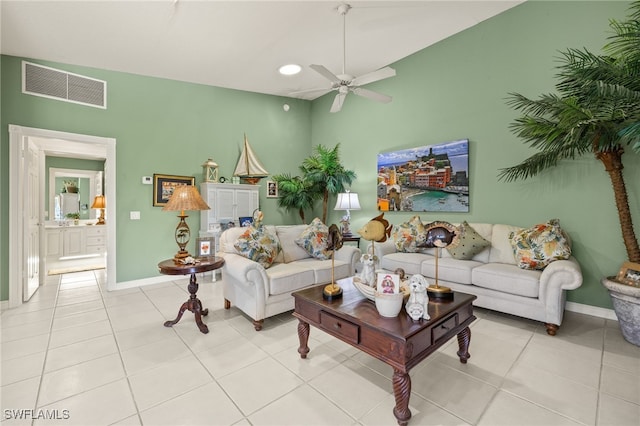 living area with light tile patterned flooring, visible vents, baseboards, and a ceiling fan