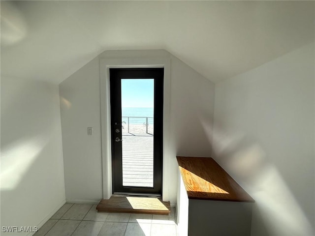 484 Gulf Bend Dr, Captiva, FL 33924 - doorway to outside with light tile patterned floors and vaulted ceiling