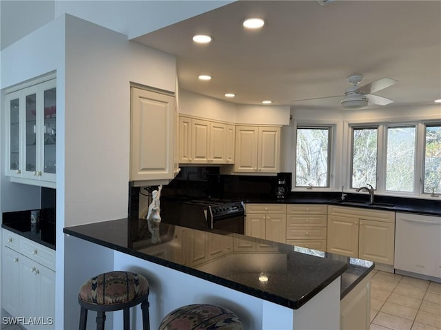 484 Gulf Bend Dr, Captiva, FL 33924 - kitchen featuring a ceiling fan, black gas range oven, plenty of natural light, white dishwasher, and a sink