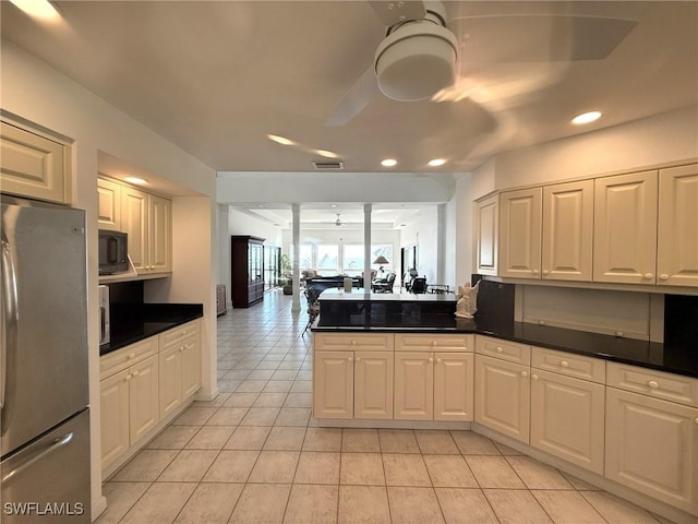 484 Gulf Bend Dr, Captiva, FL 33924 - kitchen featuring a ceiling fan, dark countertops, freestanding refrigerator, black microwave, and light tile patterned floors