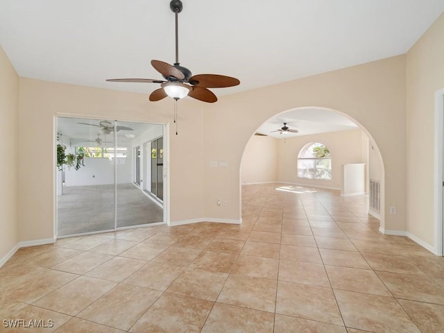 4538 SE 6th Ct, Cape Coral, FL 33904 - empty room featuring visible vents, baseboards, ceiling fan, light tile patterned floors, and arched walkways