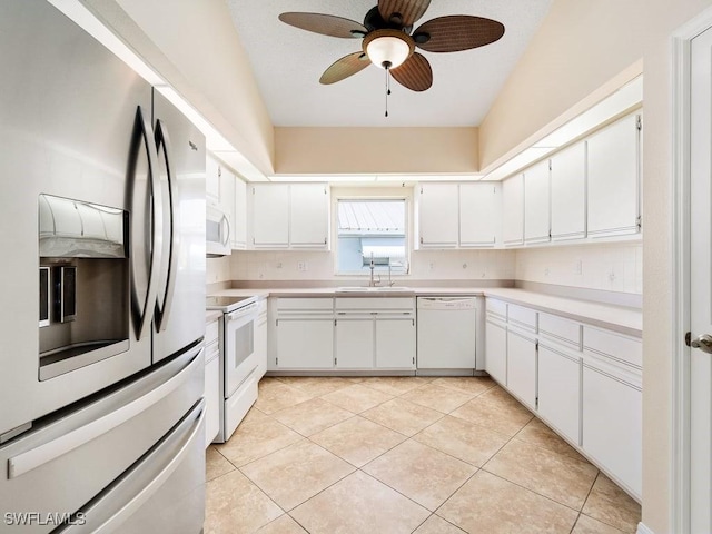 4538 SE 6th Ct, Cape Coral, FL 33904 - kitchen featuring white appliances, light tile patterned floors, a ceiling fan, a sink, and light countertops