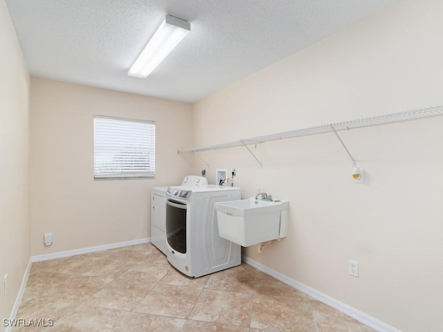 4538 SE 6th Ct, Cape Coral, FL 33904 - laundry room with independent washer and dryer, a sink, a textured ceiling, baseboards, and laundry area