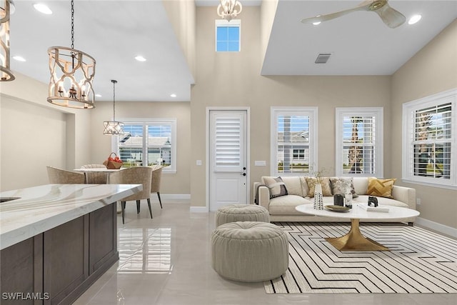 7282 Saona Ct, Naples, FL 34113 - living room featuring breakfast area, baseboards, a chandelier, a towering ceiling, and recessed lighting