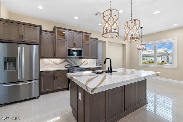 7282 Saona Ct, Naples, FL 34113 - kitchen featuring stainless steel appliances, a sink, a chandelier, tasteful backsplash, and recessed lighting