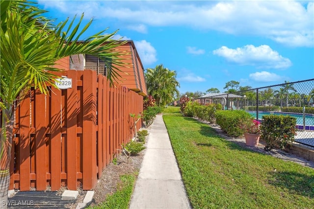 view of home's exterior featuring a yard and fence