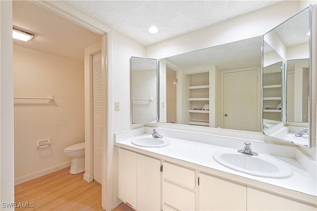 full bathroom featuring a closet, a textured ceiling, and a sink