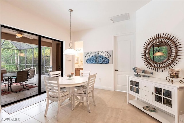 dining room featuring a ceiling fan, light tile patterned floors, and baseboards