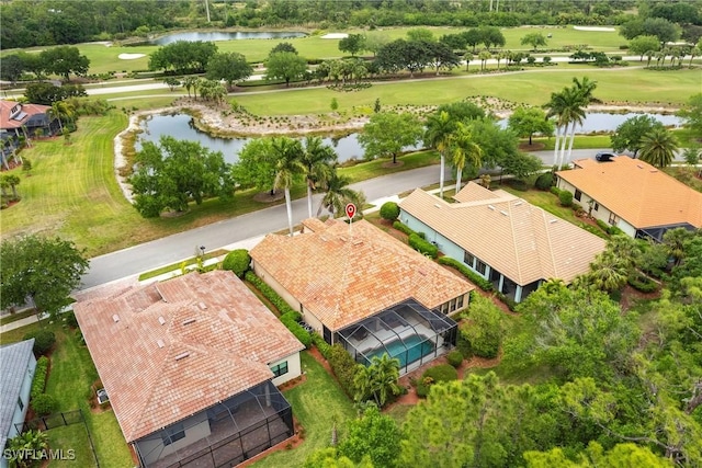 drone / aerial view with view of golf course and a water view