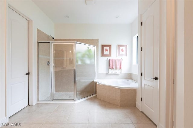 bathroom with a bath, a stall shower, and a wealth of natural light