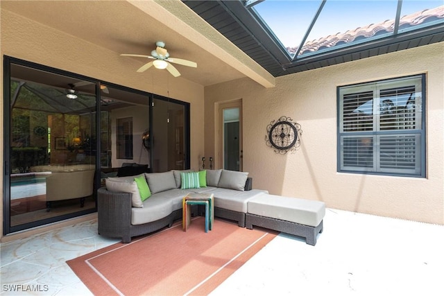 view of patio / terrace with an outdoor living space, ceiling fan, and glass enclosure