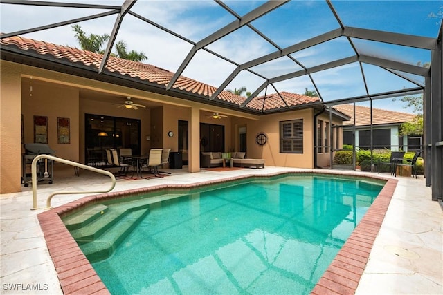outdoor pool featuring a ceiling fan, a lanai, an outdoor living space, and a patio