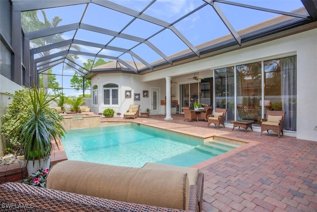 view of swimming pool with a pool with connected hot tub, ceiling fan, and a patio