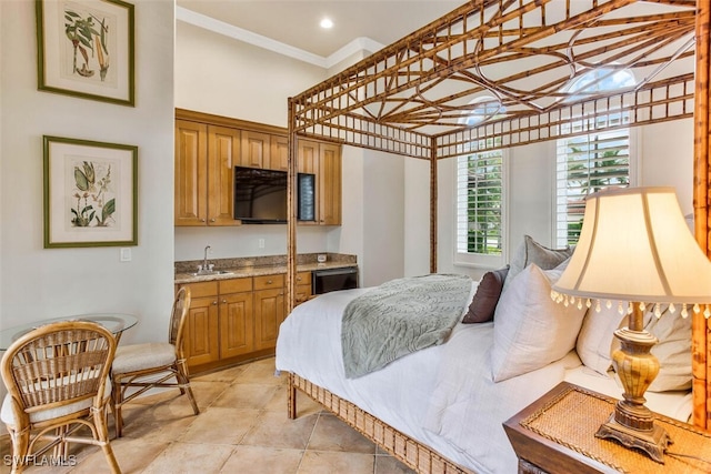 bedroom with ornamental molding, indoor wet bar, a sink, and light tile patterned floors