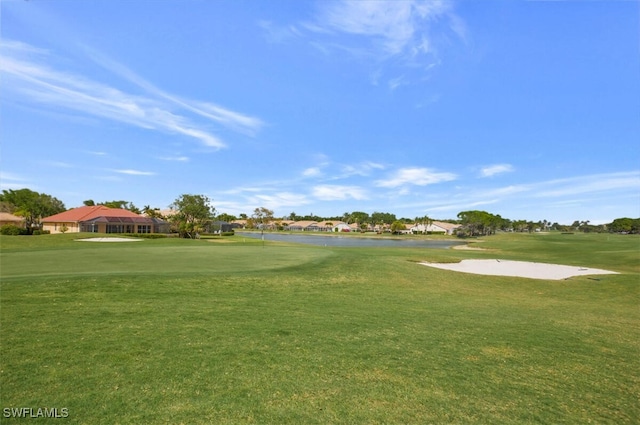 surrounding community featuring view of golf course and a yard