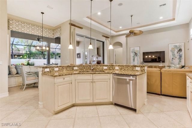 kitchen featuring a tray ceiling, open floor plan, visible vents, and dishwasher