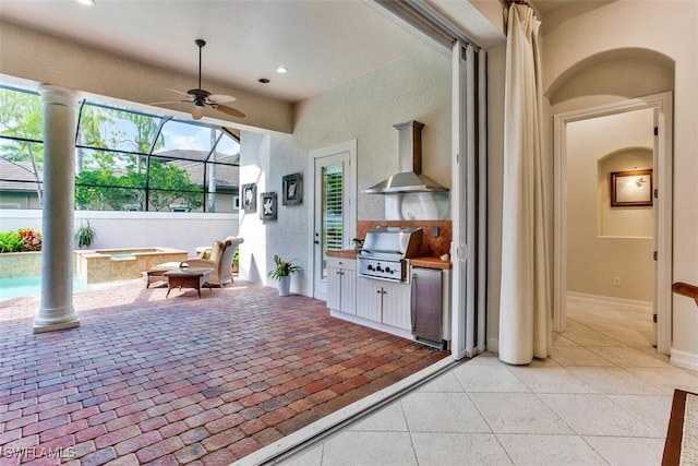 exterior space featuring baseboards, ceiling fan, wall chimney exhaust hood, recessed lighting, and stainless steel refrigerator