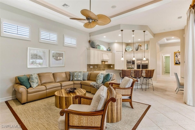 living area featuring recessed lighting, light tile patterned floors, arched walkways, ceiling fan, and visible vents