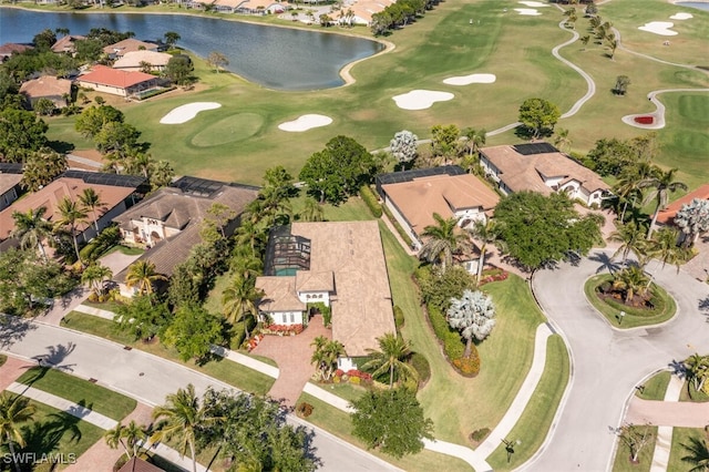 birds eye view of property with golf course view, a water view, and a residential view