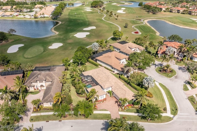 aerial view with a water view, view of golf course, and a residential view