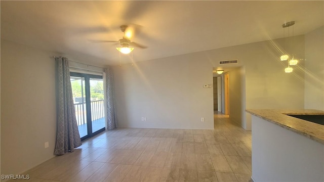spare room featuring visible vents and a ceiling fan