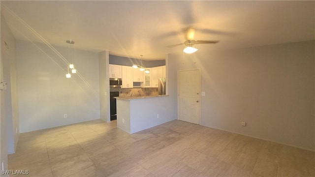 unfurnished living room with ceiling fan