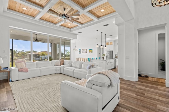 16768 San Edmundo Rd, Punta Gorda, FL 33955 - living room with coffered ceiling, dark wood-style flooring, a ceiling fan, a wooden ceiling with exposed beams, and recessed lighting