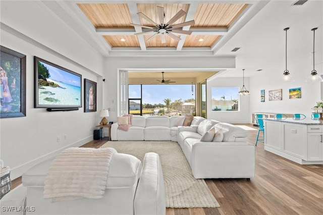 16768 San Edmundo Rd, Punta Gorda, FL 33955 - living area with coffered ceiling, wood finished floors, recessed lighting, a ceiling fan, and a chandelier
