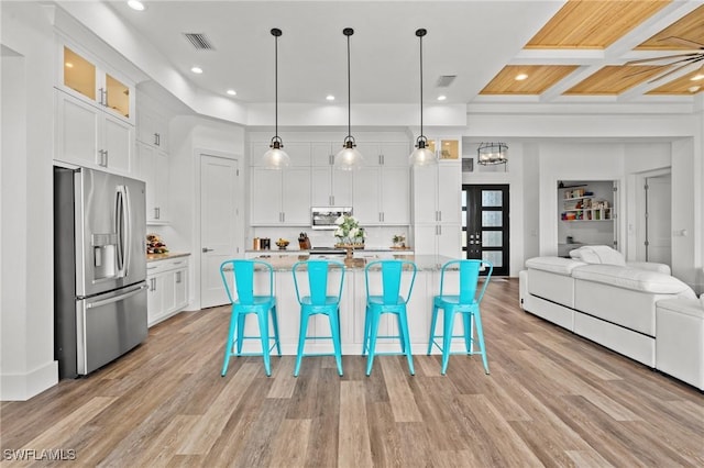 16768 San Edmundo Rd, Punta Gorda, FL 33955 - kitchen with stainless steel appliances, white cabinets, open floor plan, light wood-style flooring, and recessed lighting