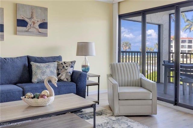 2445 W Gulf Dr Unit 21E, Sanibel, FL 33957 - living room featuring wood finished floors and baseboards