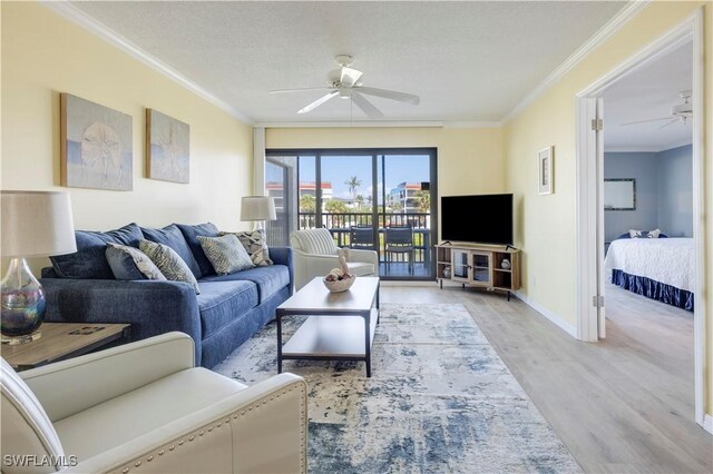2445 W Gulf Dr Unit 21E, Sanibel, FL 33957 - living area featuring baseboards, wood finished floors, a ceiling fan, and ornamental molding