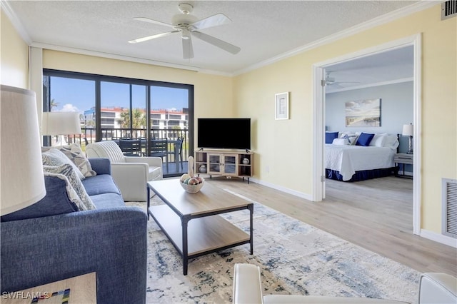 2445 W Gulf Dr Unit 21E, Sanibel, FL 33957 - living area featuring wood finished floors, a textured ceiling, ceiling fan, and ornamental molding