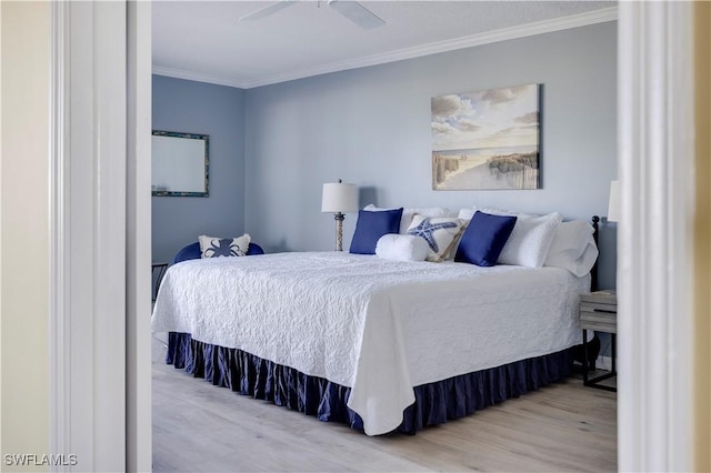 2445 W Gulf Dr Unit 21E, Sanibel, FL 33957 - bedroom featuring ceiling fan, light wood-style floors, and ornamental molding