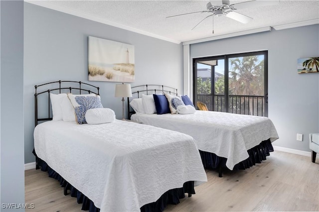 2445 W Gulf Dr Unit 21E, Sanibel, FL 33957 - bedroom with a textured ceiling, crown molding, baseboards, and wood finished floors