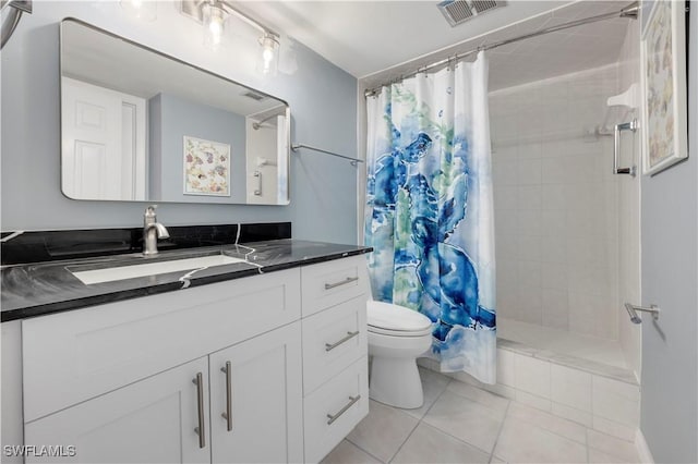 2445 W Gulf Dr Unit 21E, Sanibel, FL 33957 - bathroom featuring visible vents, toilet, tiled shower, tile patterned floors, and vanity