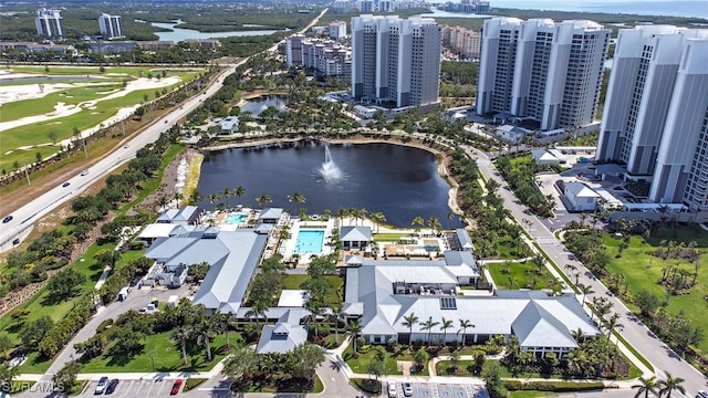 aerial view of property and surrounding area featuring a large body of water and a local golf course