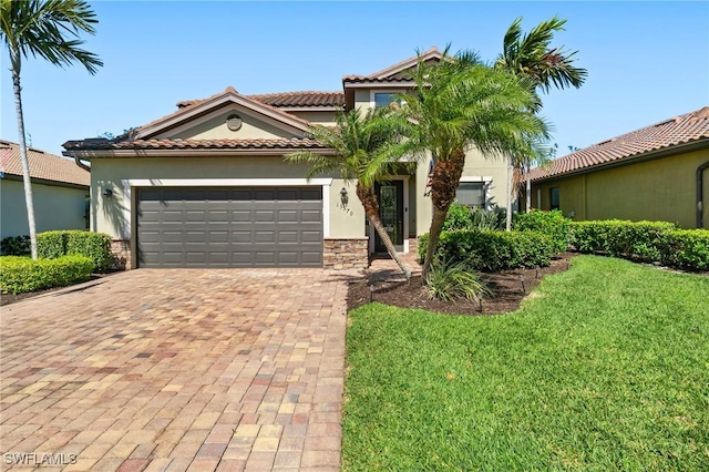 13570 San Georgio Dr, Estero, FL 33928 - mediterranean / spanish-style house featuring a tile roof, a front yard, stucco siding, decorative driveway, and a garage