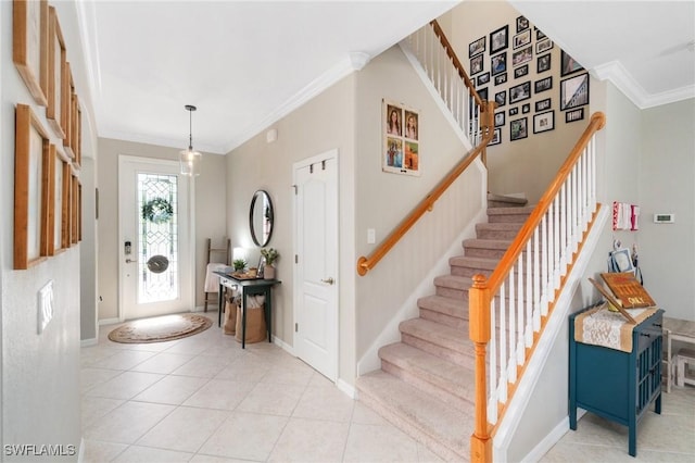 13570 San Georgio Dr, Estero, FL 33928 - entryway featuring light tile patterned floors, stairs, baseboards, and crown molding
