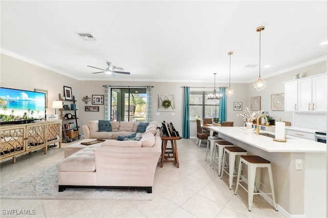 13570 San Georgio Dr, Estero, FL 33928 - living area featuring light tile patterned flooring, ornamental molding, visible vents, and ceiling fan with notable chandelier
