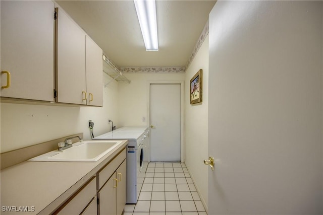 laundry room featuring light tile patterned flooring, washer and dryer, cabinet space, and a sink