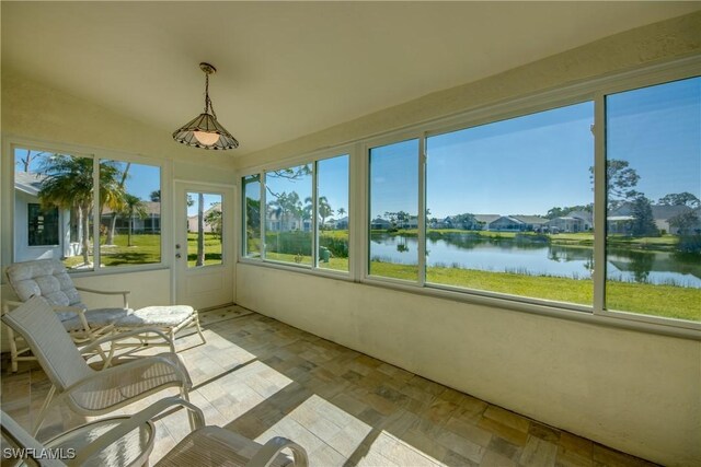unfurnished sunroom featuring a water view