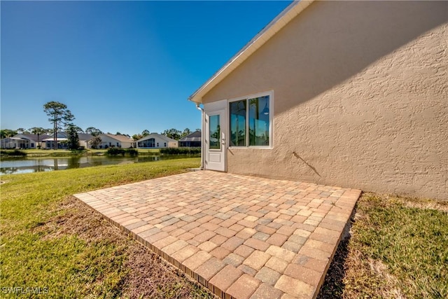 view of patio / terrace with a residential view and a water view