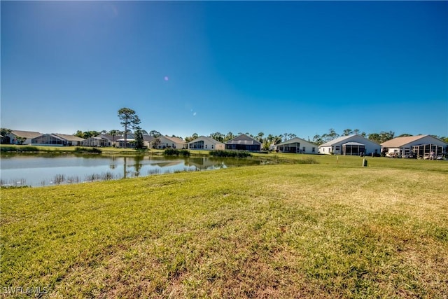 view of yard featuring a residential view and a water view